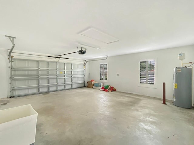 garage featuring electric water heater and a garage door opener