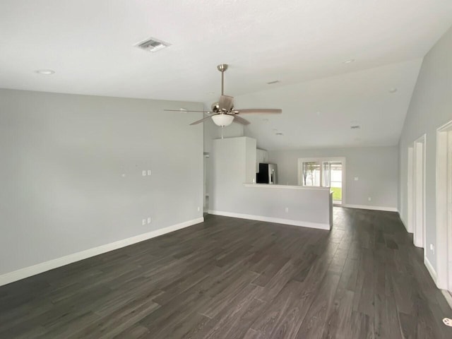 unfurnished living room featuring dark hardwood / wood-style flooring, vaulted ceiling, and ceiling fan