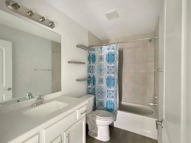 full bathroom featuring hardwood / wood-style floors, vanity, toilet, and shower / tub combo