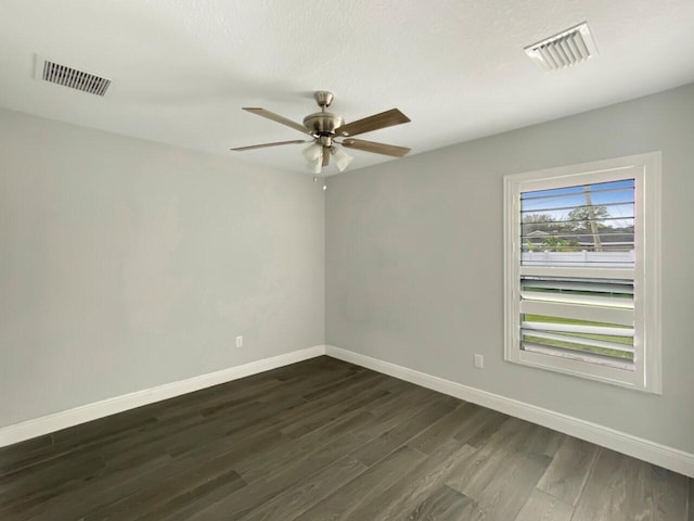 unfurnished room with dark hardwood / wood-style flooring and ceiling fan