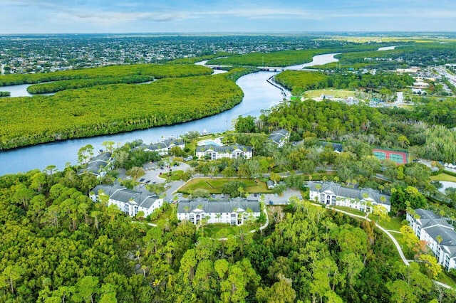 aerial view featuring a residential view, a water view, and a view of trees