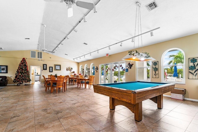 recreation room with a textured ceiling, vaulted ceiling, rail lighting, and ceiling fan