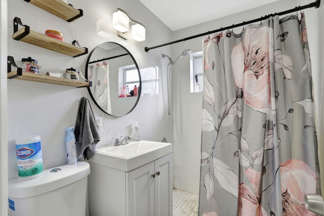 bathroom with vanity, curtained shower, and toilet