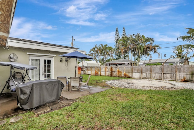 view of yard with a patio and french doors