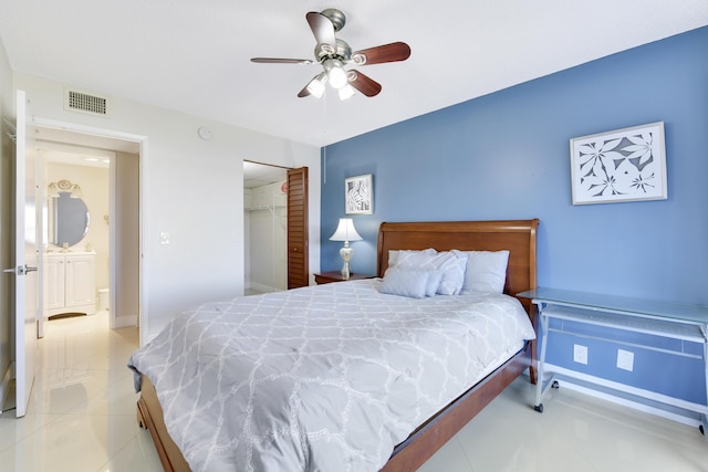 bedroom featuring light tile patterned floors, a closet, and ceiling fan