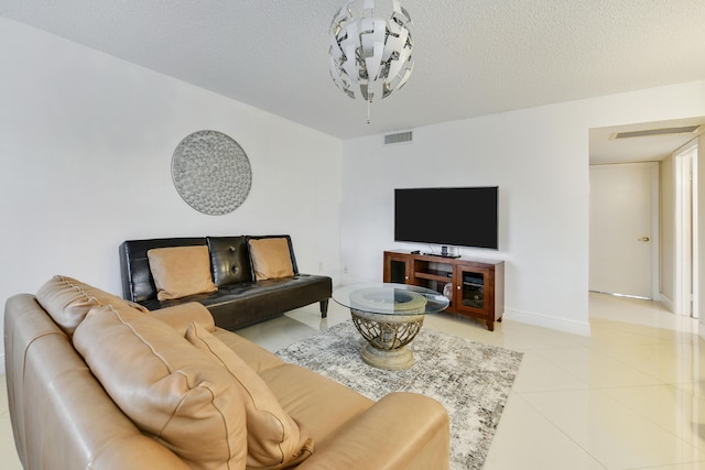 living room featuring light tile patterned floors and a textured ceiling