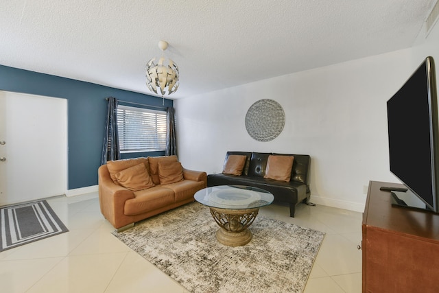 tiled living room featuring a textured ceiling and a notable chandelier