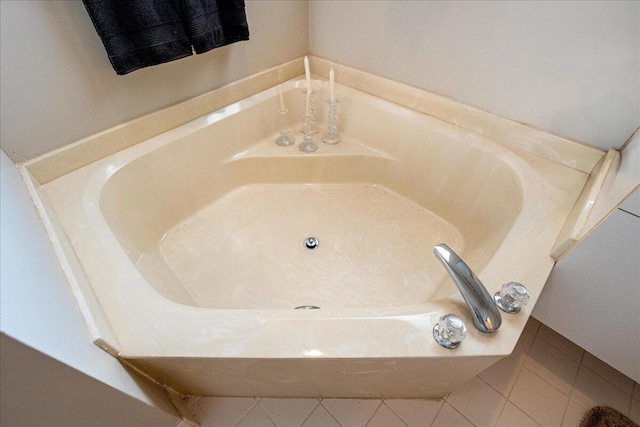 bathroom featuring tile patterned floors and a tub