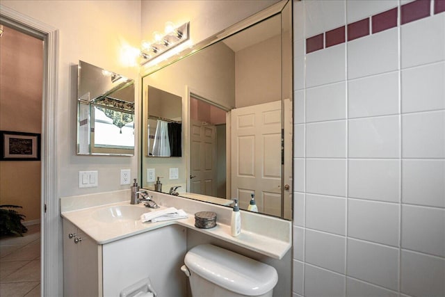 bathroom featuring tile patterned flooring, vanity, and toilet