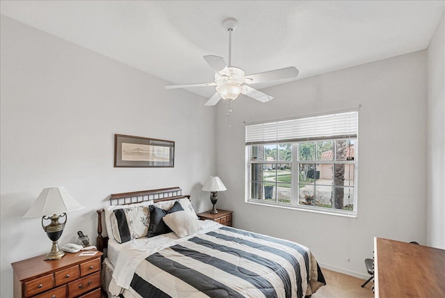 bedroom with light carpet and ceiling fan