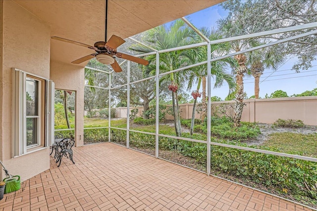 unfurnished sunroom featuring ceiling fan