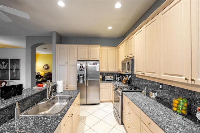 kitchen featuring light brown cabinets, light tile patterned floors, sink, and appliances with stainless steel finishes