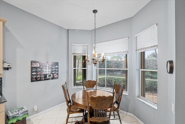 dining area with plenty of natural light, light tile patterned floors, and an inviting chandelier