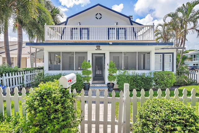 view of front facade with a sunroom and a balcony