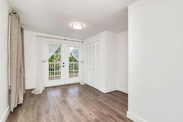 empty room featuring hardwood / wood-style floors and french doors