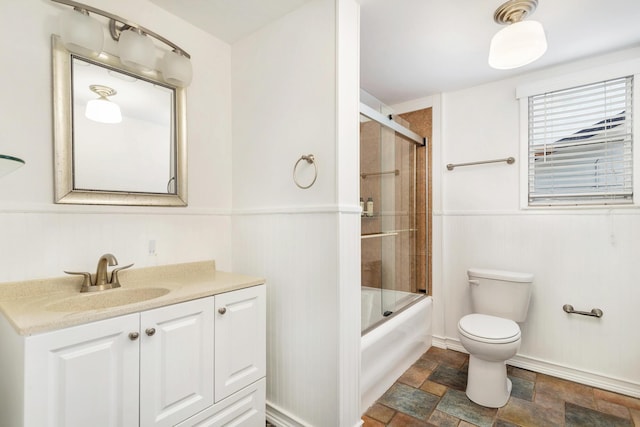 full bathroom with toilet, vanity, and combined bath / shower with glass door