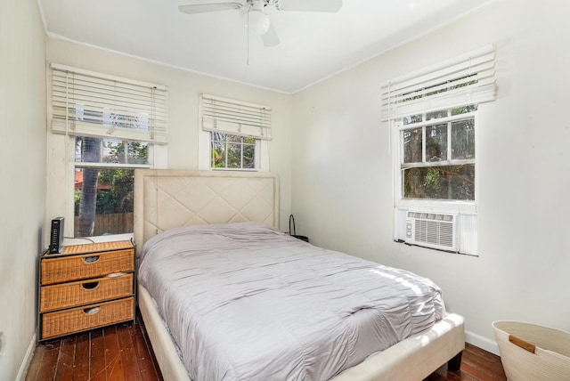 bedroom featuring ceiling fan, cooling unit, and dark wood-type flooring