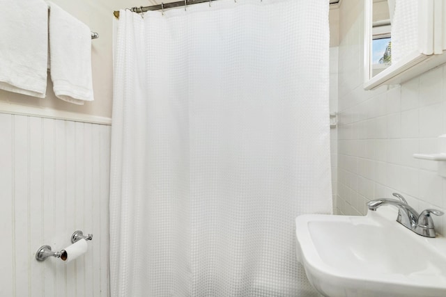 bathroom with walk in shower and sink