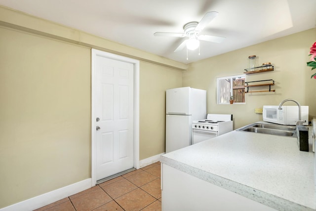 kitchen featuring ceiling fan, sink, light tile patterned floors, and white appliances