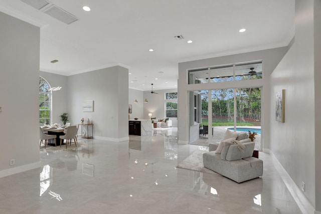 living room featuring ceiling fan and crown molding