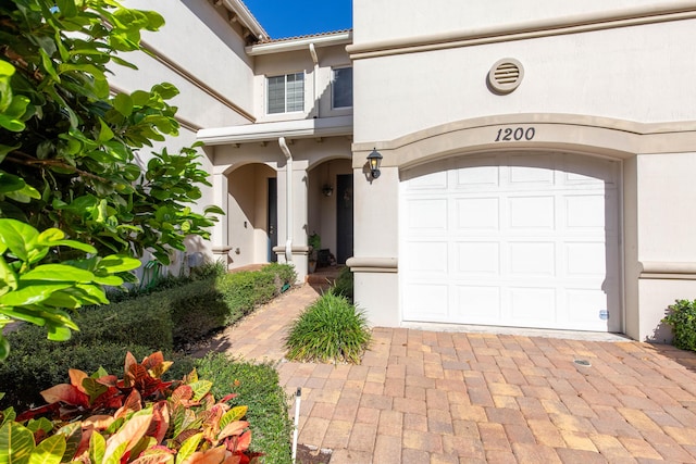 doorway to property with a garage