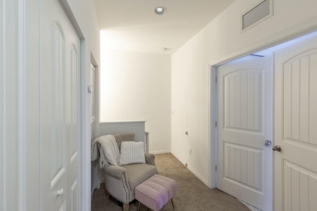 sitting room with light colored carpet