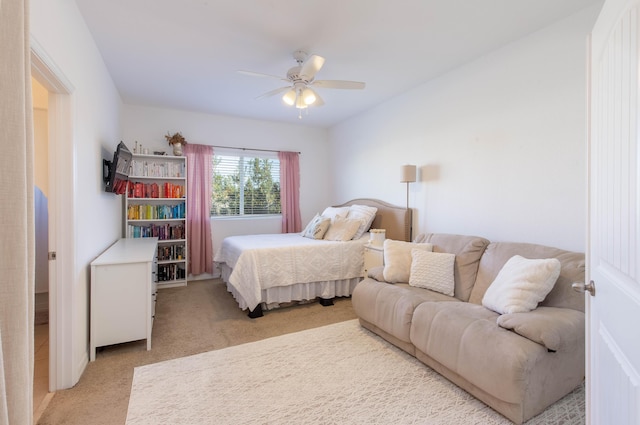 bedroom featuring ceiling fan and light carpet