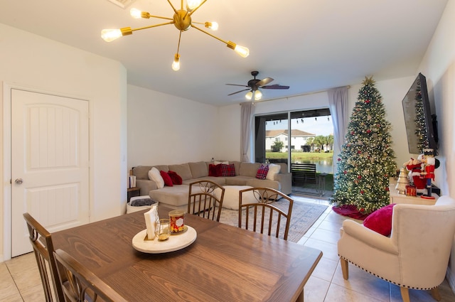 dining room with ceiling fan with notable chandelier and light tile patterned flooring