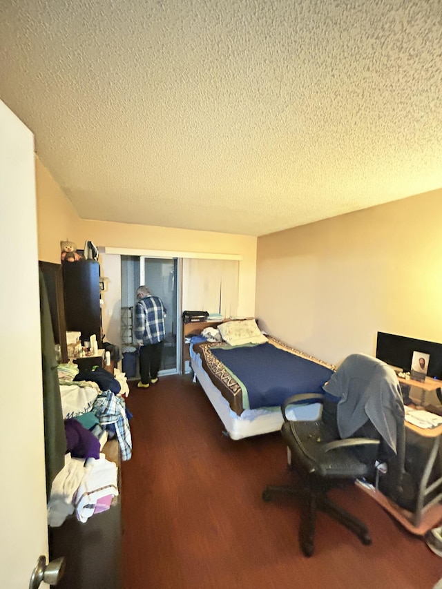 bedroom with hardwood / wood-style floors and a textured ceiling