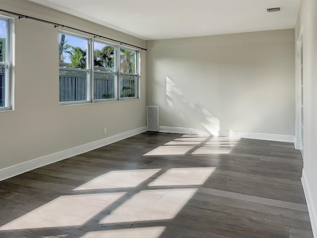 empty room with dark wood-type flooring