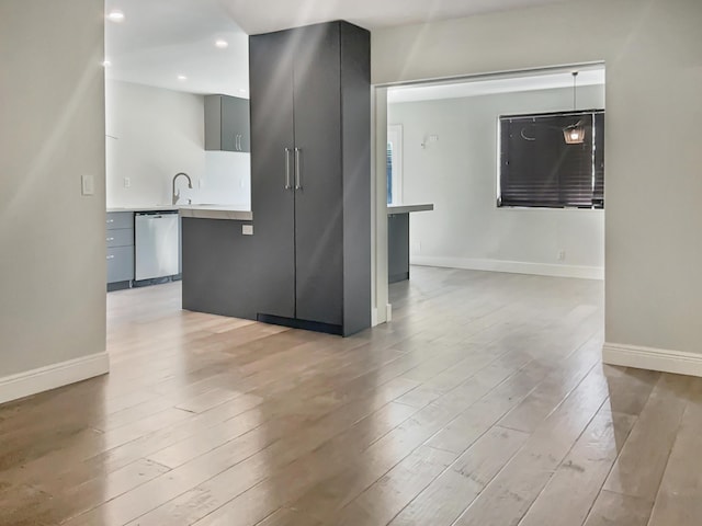 empty room with light hardwood / wood-style floors and sink