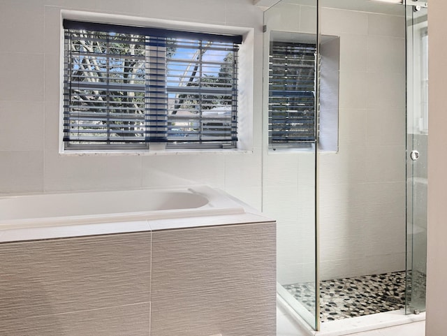 bathroom featuring plus walk in shower