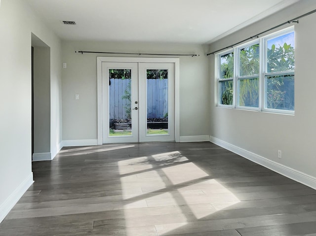 unfurnished room with french doors and dark wood-type flooring