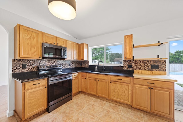 kitchen featuring decorative backsplash, sink, vaulted ceiling, and appliances with stainless steel finishes