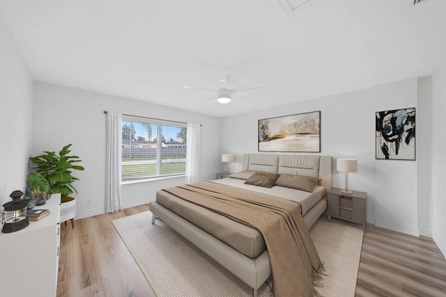 bedroom featuring light wood-type flooring and ceiling fan