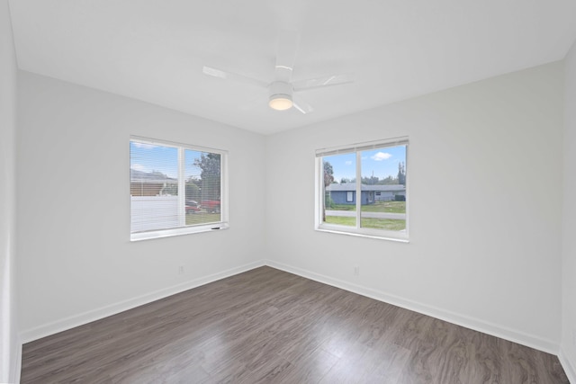 unfurnished room featuring ceiling fan and dark wood-type flooring