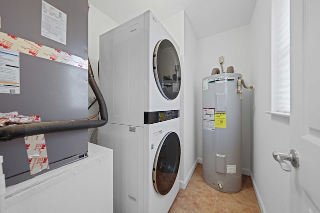 laundry area with light tile patterned floors, stacked washer / dryer, and water heater