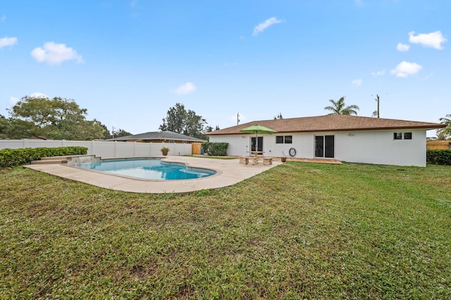 view of pool with a yard and a patio