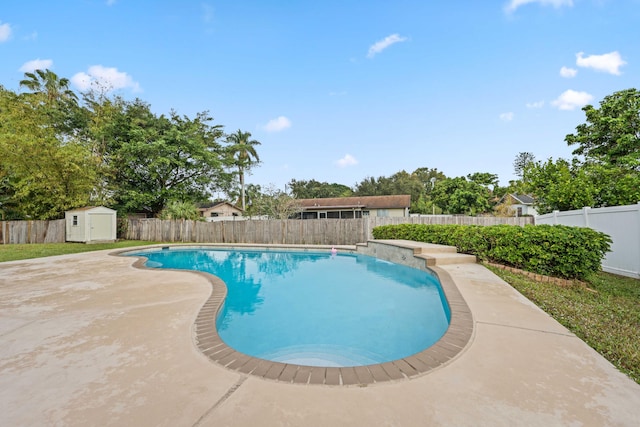 view of swimming pool with a storage shed