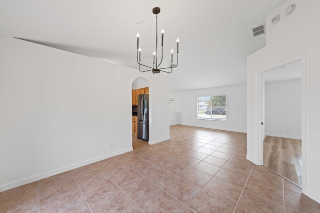 unfurnished dining area with light tile patterned floors and a chandelier