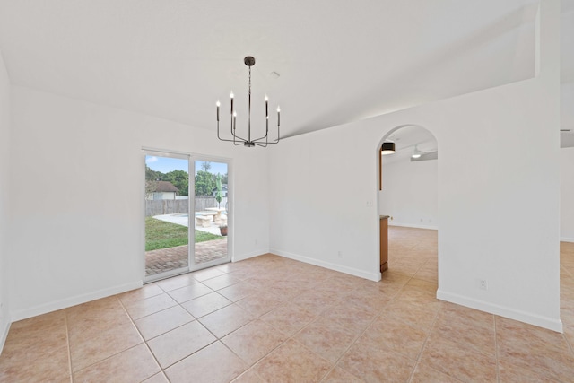 unfurnished dining area featuring light tile patterned floors and ceiling fan with notable chandelier