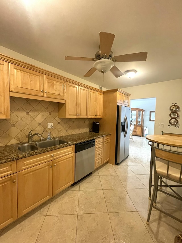 kitchen with decorative backsplash, stainless steel appliances, light tile patterned flooring, and sink