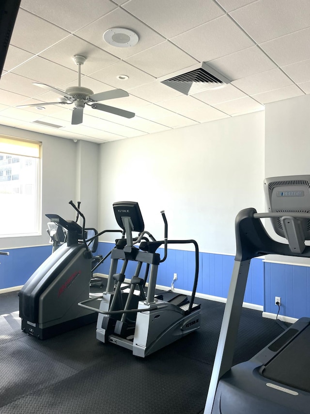 workout area featuring a drop ceiling and ceiling fan