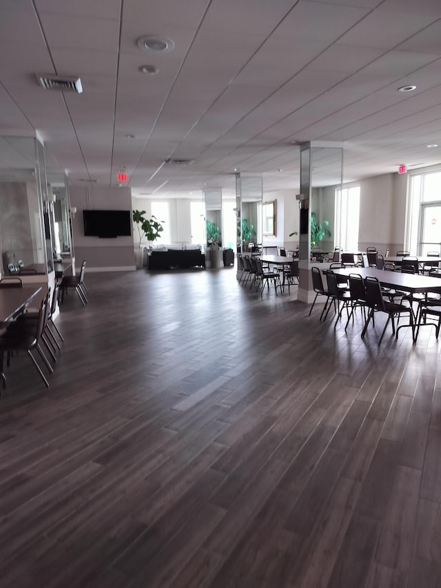 dining space with dark hardwood / wood-style flooring and a healthy amount of sunlight