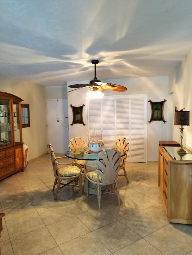 dining space featuring ceiling fan and light tile patterned flooring