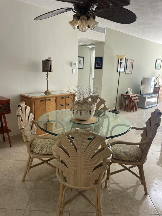 dining area with ceiling fan and light tile patterned floors