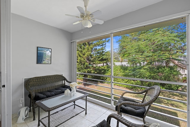 sunroom / solarium featuring ceiling fan