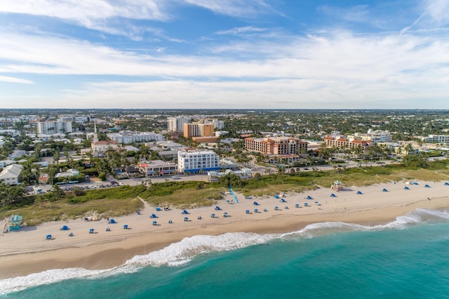 aerial view with a water view and a view of the beach