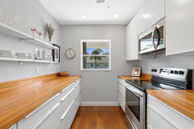 kitchen with wood counters and appliances with stainless steel finishes