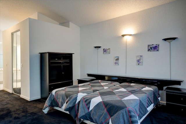 carpeted bedroom with lofted ceiling